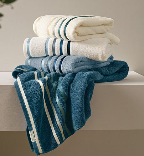 pila de toallas dobladas en una mesada de baño